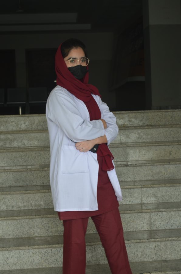 NEI clinical student in lab coat